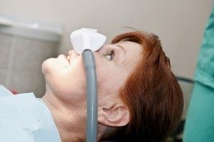 Woman receiving nitrous oxide as part of dental sedation service